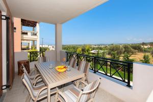 a table and chairs on a balcony with a view at Cottage in Adele in Ádhele