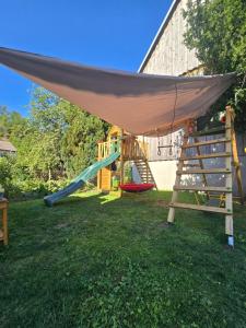a playground with a hammock and a slide at Merci's - Legoland - Garden - Parking - Klima AC in Günzburg