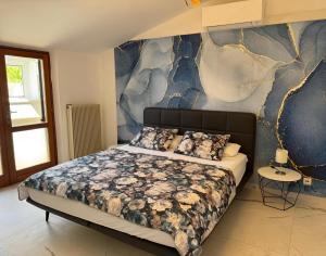 a bedroom with a bed and a blue and white wall at BeachfrontGrado Seaview Apartment Costa Azzurra in Grado