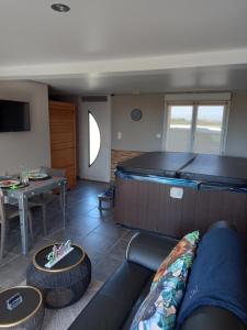 a living room with a couch and a table at Un moment zen à Warhem in Warhem