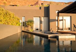 a house with a swimming pool in front of a house at Anzo Villas in Oia