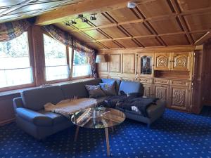 a living room with a couch and a table at Appart Alte Post in Partenen