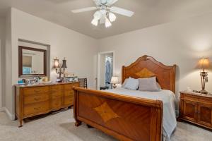 a bedroom with a large wooden bed and a dresser at Permana Apartment in Manila +7 photos