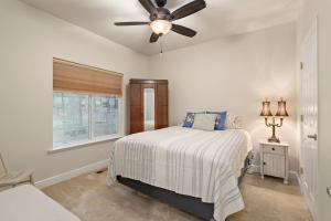 a bedroom with a bed and a ceiling fan at Permana Apartment in Manila