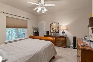 a bedroom with a bed and a dresser and a mirror at Permana Apartment in Manila