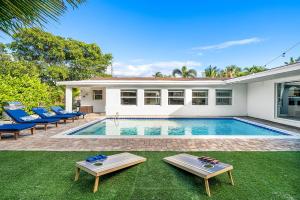a swimming pool in the backyard of a house at Backyard Oasis with Pool & Games in West Palm Beach