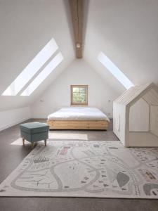 a attic bedroom with a bed and a rug at Apartmány Vysoké in Vysoké nad Jizerou