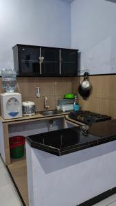 a kitchen with a sink and a stove top oven at Bromo Jay House Homestay I in Sukapura +10 photos