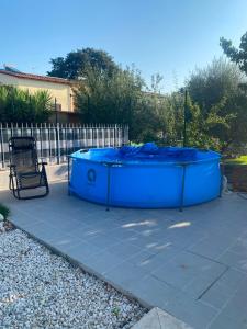 a blue tub sitting on a patio with a chair at Oasi 29 in Morlupo +5 photos