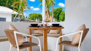 a table and two chairs on a porch with a table at Lavoe Villas Samui in Nathon Bay