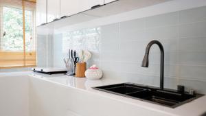 a kitchen counter with a sink and a window at Lavoe Villas Samui in Nathon Bay +18 photos