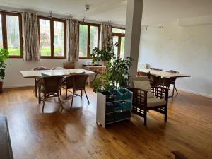 a living room with tables and chairs and windows at Normandy Inn in Montbray