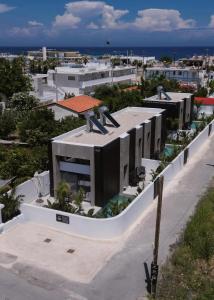 a building with a statue on the roof of it at Three Doors Villa Complex-Faliraki in Faliraki