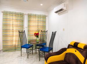 a dining room with a table and chairs and a couch at Ouedraogo Property Management in Ouagadougou