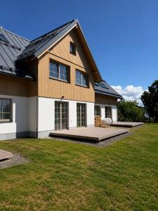 a house with a large yard in front of it at Apartmány Vysoké in Vysoké nad Jizerou