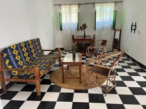 a living room with chairs and a table at Meama Paje Guesthouse in Paje