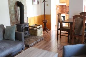 a living room with a wood stove and a table at Apartmán Nelinka in Rudná pod Pradědem