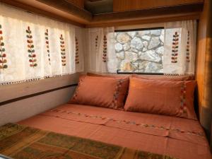 a bed in a room with a window at Ecoglamping Tramonti in Tramonti