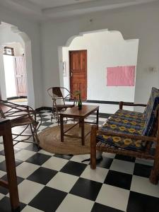 a living room with a couch and a table at Meama Paje Guesthouse in Paje