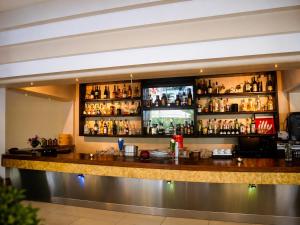 a bar in a hotel with a lot of alcohol at Galini Hotel in Agia Marina Aegina