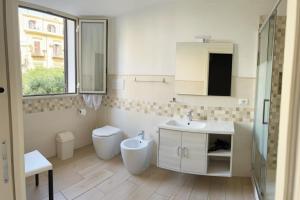 a bathroom with a sink and a toilet at Opera Prima 28 in Palermo +44 photos