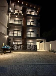 a large building with lights on it at night at Oceana Trinco in Trincomalee