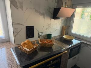 a kitchen with two baskets of food on a counter at La casa de Ángel in Llombera +15 photos