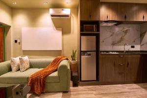 a living room with a couch and a kitchen at The Chevron House in Ikuata