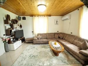 a living room with a couch and a table at Vila Muca in Peshkopi