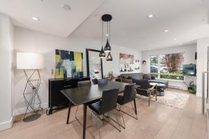 a dining room and living room with a table and chairs at Elite Townhouse @ the Shipyards in North Vancouver