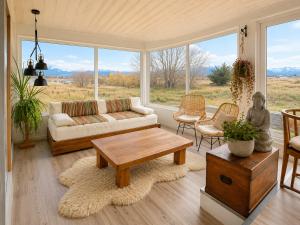 a living room with a couch and a table at Domos by Toore Patagonia in Puerto Natales