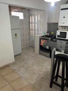 a kitchen with a stove and a refrigerator at Depto hube in La Banda +6 photos