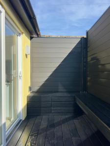 a privacy fence on a balcony of a house at Buttercup Victorian House for 6 in St. Leonards +5 photos