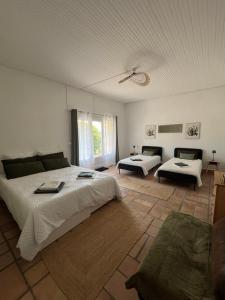 a large bedroom with two beds and a couch at L'Échappée Cévenole in Gagnières