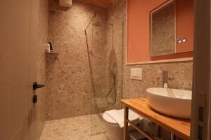 a bathroom with a sink and a shower at Eden Center Rooms in Durrës +33 photos