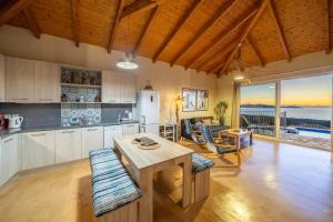 a kitchen with a table and a view of the ocean at Villa Dioni in Fiskardo