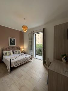 a bedroom with a bed and a sliding glass door at Opera Prima 28 in Palermo