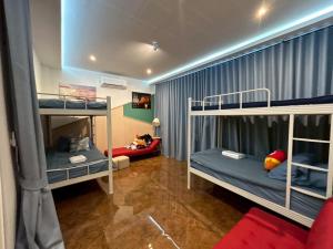 a room with two bunk beds and a couch at ซันไบร์ท พลูวิลล่า 2 in Ban Huai Yai +16 photos