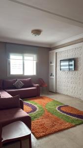 a living room with a couch and a rug at Chez Iceyy in Tangier