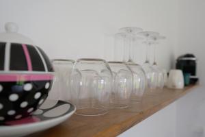 a row of wine glasses sitting on a shelf at Les Pieds au vert in Limbourg