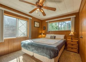 a bedroom with a bed and a ceiling fan at Bear's Den in Idyllwild