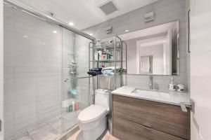 a bathroom with a toilet and a sink and a shower at Elite Townhouse @ the Shipyards in North Vancouver +22 photos