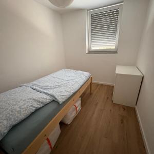 a small bedroom with a bed and a window at TourBase Dahlem in Dahlem