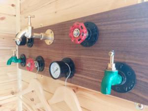a bathroom with four different types of clocks on the wall at Knocknafallia in Cappoquin
