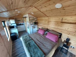a bedroom with a bed in a wooden room at Knocknafallia in Cappoquin