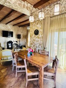 a dining room with a wooden table and chairs at Дом Каролино-Бугаз у моря in Zatoka