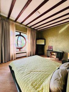 a bedroom with a large bed and a window at Дом Каролино-Бугаз у моря in Zatoka