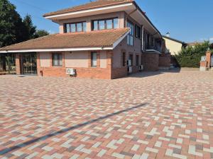 a brick house with a brick driveway in front of it at B&B Monviso in Casavecchie