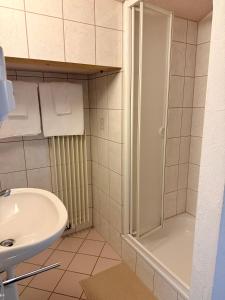 a bathroom with a shower and a sink at Hotel Alp Sur in Mühlen