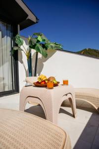 a wicker table with a plate of food on it at Guney House by Villa Safiya in Fethiye